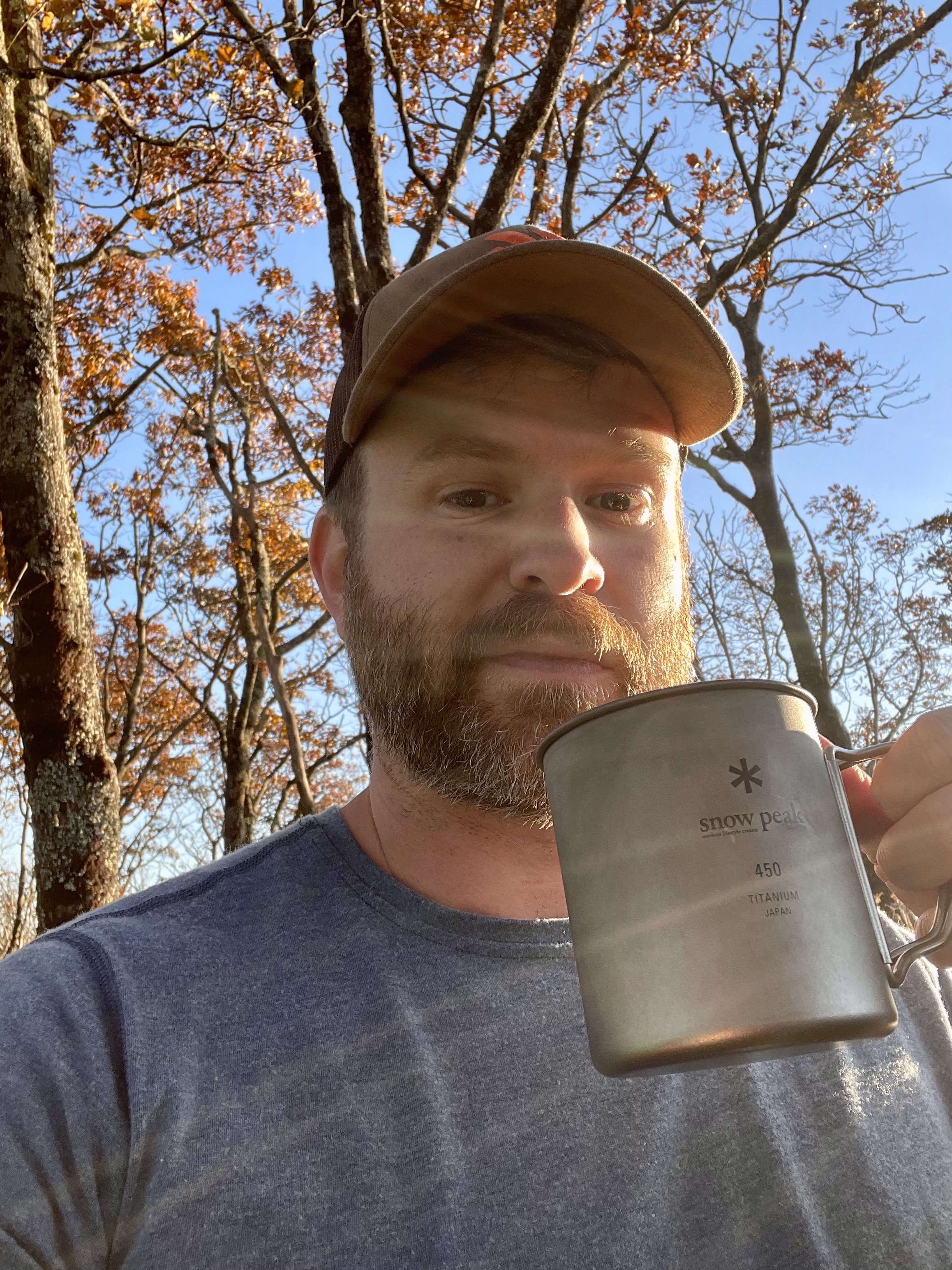 Hugh enjoying an evening drink while enjoying the view from the top of Standing Indian Mountain in the Southern Nantahala Wilderness